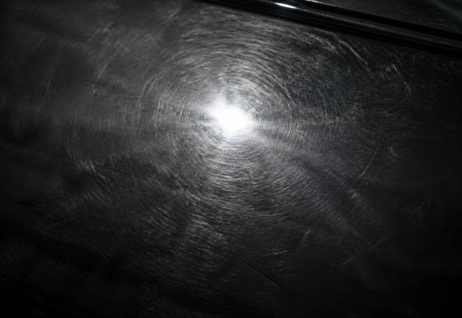 Black paint with heavy swirl marks and haze under inspection light